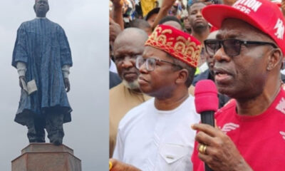 Two-panel scene: a tall statue in a blue robe on a pedestal left, and a man in a red cap speaking into a pink microphone at a crowd on the right.