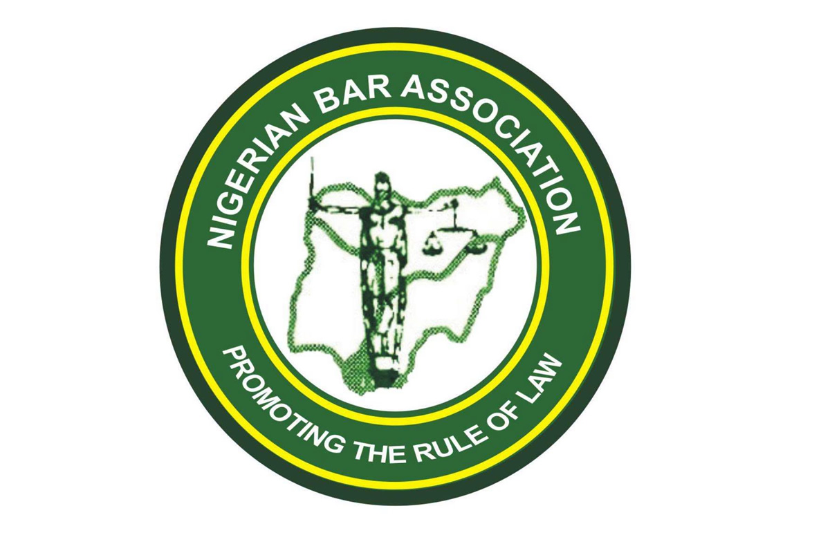 Circular logo of the Nigerian Bar Association with the slogan 'Promoting the Rule of Law' around the rim and a central figure holding scales over a map outline of Nigeria, in green and yellow.
