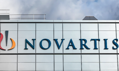 Novartis logo and name displayed on a modern office building facade with blue lettering.