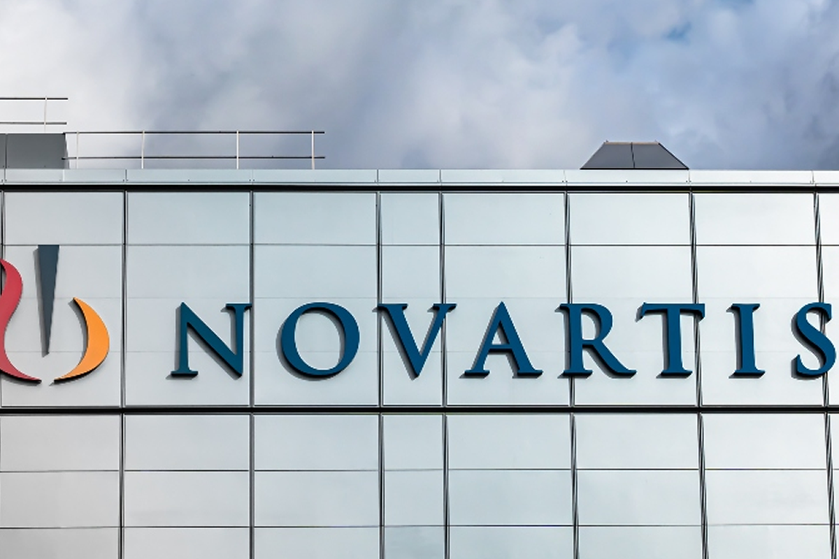 Novartis logo and name displayed on a modern office building facade with blue lettering.