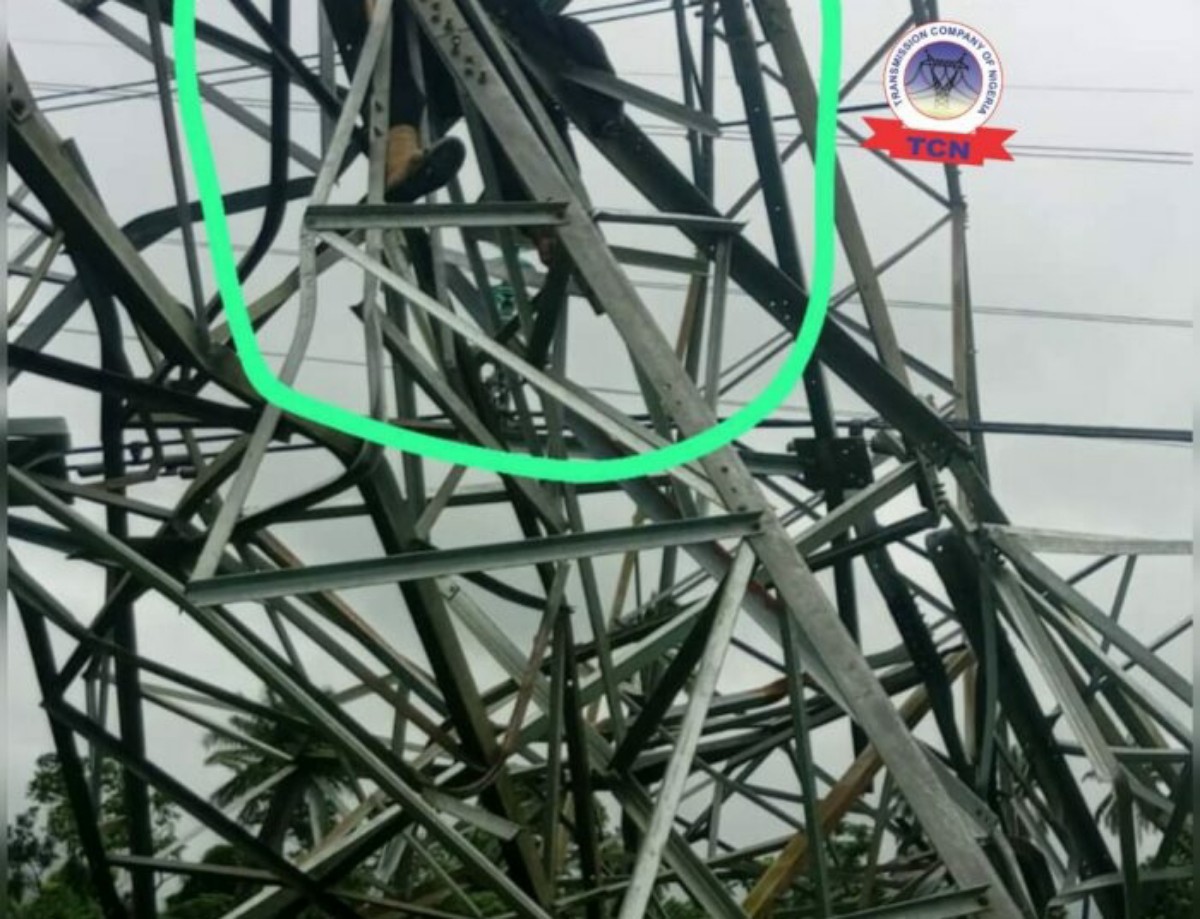 Damaged metal transmission tower with bent and tangled steel beams circled in green