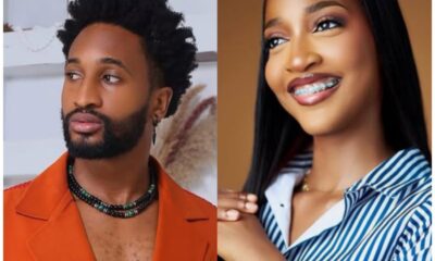 Two people are shown side by side: a man in an orange blazer with a beard and necklace, looking to the left; a smiling woman with braces and striped shirt on the right.