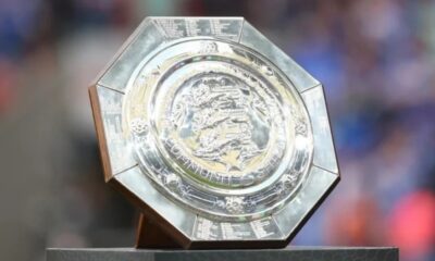 Polished silver octagonal trophy on a dark base, featuring a detailed circular center with engravings and a dragon emblem, awarded at a competition.