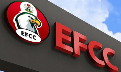 EFCC sign on a dark wall with a circular logo featuring an eagle, Nigeria’s crest, and bold red letters EFCC