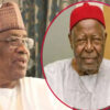 Two elderly men in traditional West African attire; left man wears glasses and a patterned cap, right man in a red fez-style hat inside a pink circle